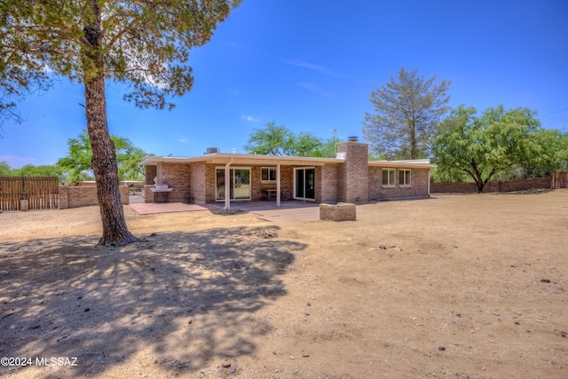 rear view of property featuring a patio