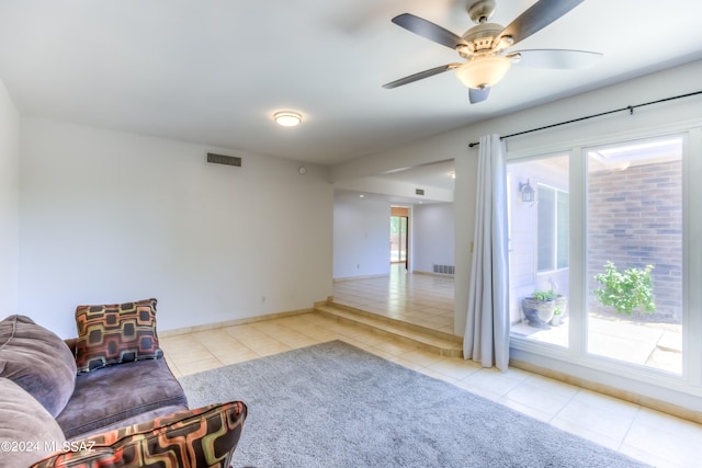 sitting room featuring ceiling fan and light tile patterned floors