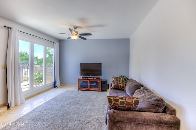 living room with ceiling fan, light tile patterned floors, and a wealth of natural light