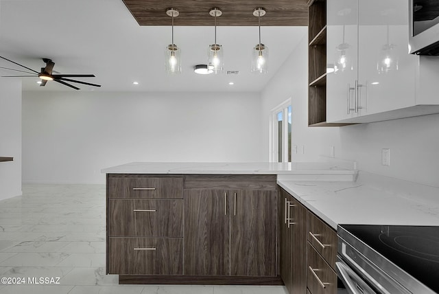 kitchen with dark brown cabinetry, light stone counters, ceiling fan, and appliances with stainless steel finishes