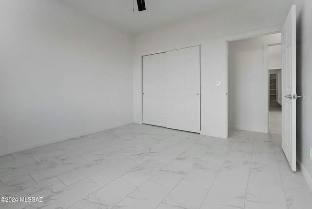 unfurnished bedroom featuring a closet and ceiling fan