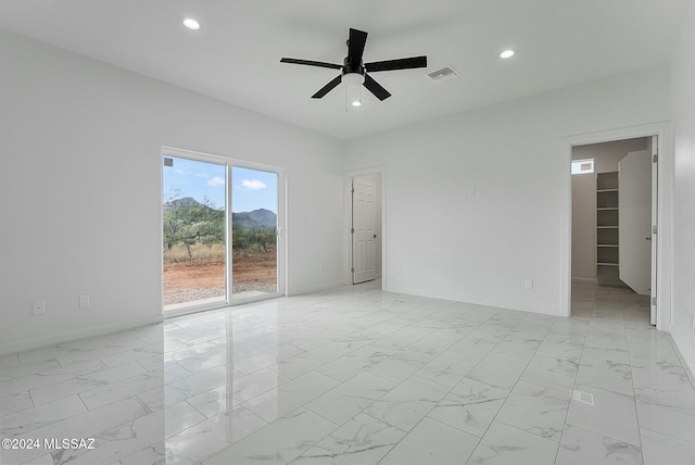 unfurnished room with ceiling fan