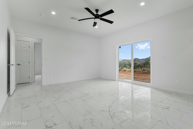 empty room with ceiling fan and a mountain view