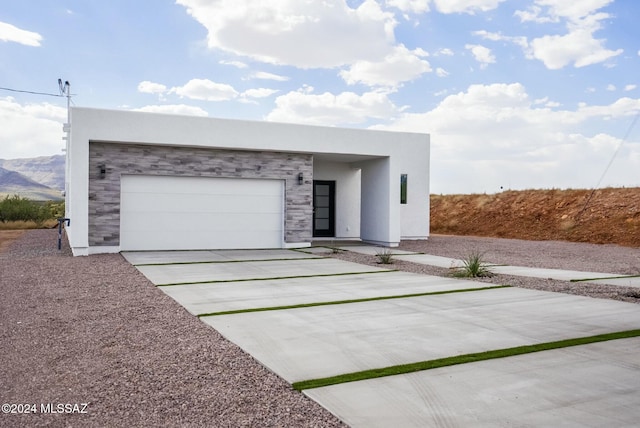 contemporary house with a mountain view and a garage