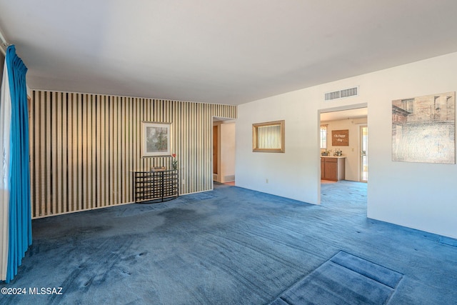 unfurnished living room featuring carpet floors and visible vents