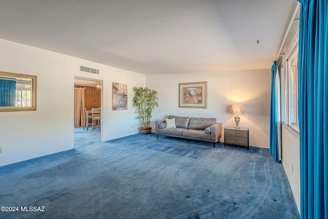 unfurnished living room featuring carpet floors and visible vents