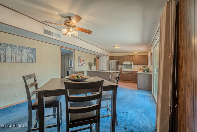 dining room with visible vents and light colored carpet