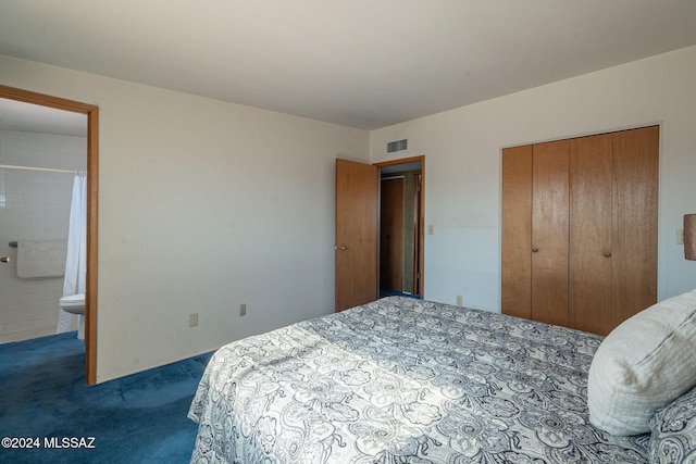 bedroom with connected bathroom, a closet, visible vents, and dark carpet