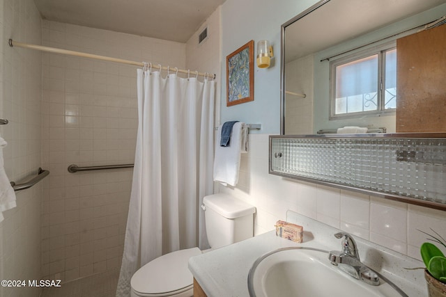 bathroom featuring visible vents, backsplash, toilet, and tiled shower