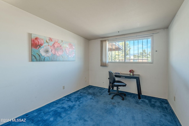 office area with vaulted ceiling and dark carpet