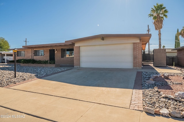 ranch-style house with brick siding, driveway, and an attached garage