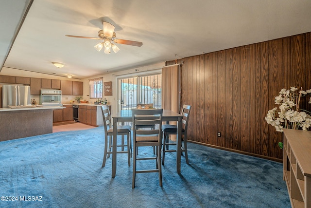 kitchen featuring visible vents, appliances with stainless steel finishes, brown cabinets, a peninsula, and light countertops