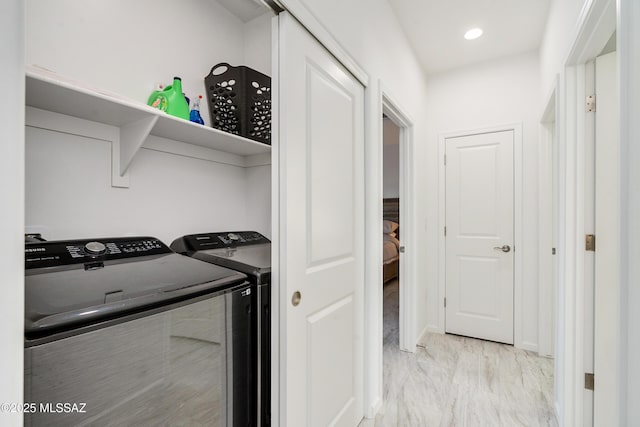 laundry room featuring marble finish floor, laundry area, washing machine and dryer, and recessed lighting