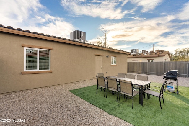 exterior space featuring a patio, a lawn, and central air condition unit