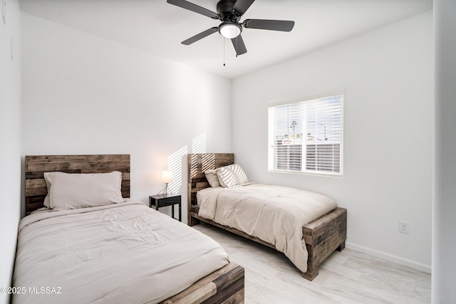 bedroom featuring a ceiling fan and baseboards