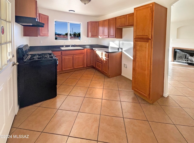 kitchen featuring light tile patterned flooring, sink, black range with gas cooktop, and exhaust hood