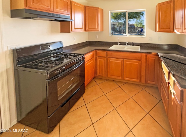 kitchen with light tile patterned flooring, sink, and black gas range oven