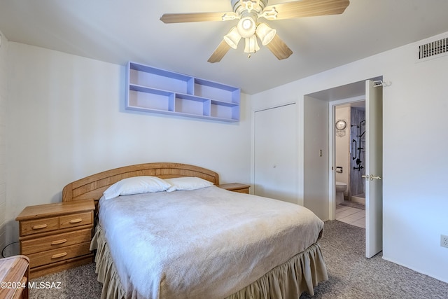 bedroom featuring carpet flooring, a closet, ensuite bath, and ceiling fan