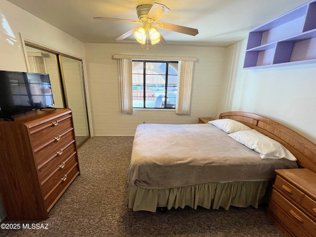 carpeted bedroom featuring ceiling fan and a closet