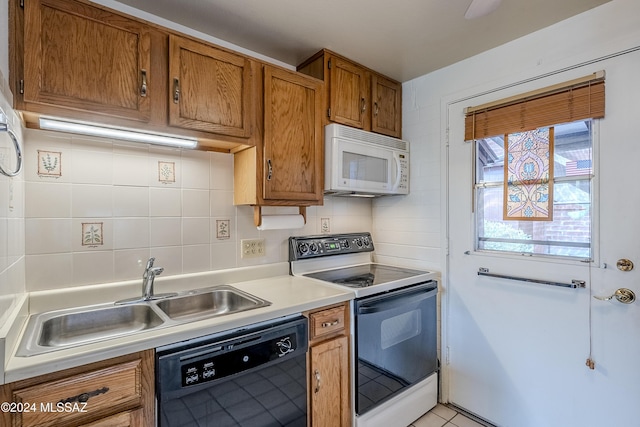 kitchen with light tile patterned flooring, white appliances, sink, and tasteful backsplash