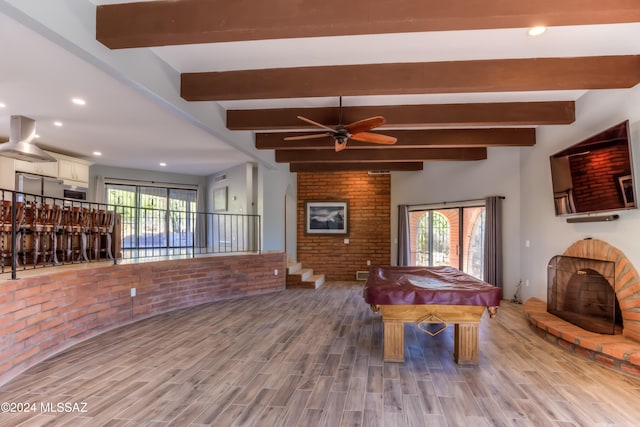 game room featuring beamed ceiling, a healthy amount of sunlight, wood-type flooring, and billiards