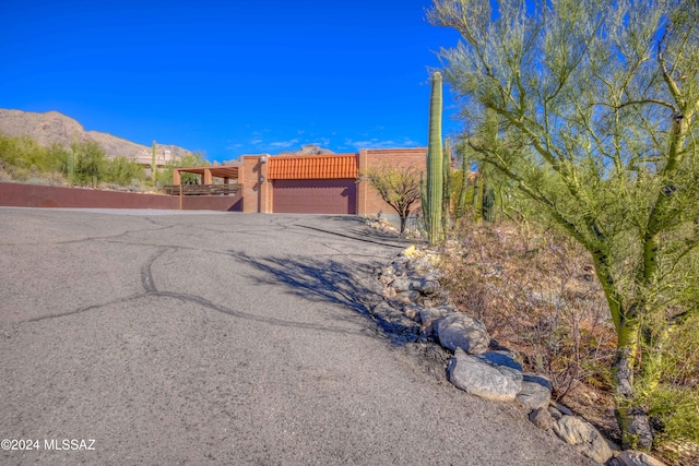 pueblo-style house featuring a mountain view and a garage