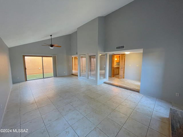 interior space featuring light tile patterned floors, high vaulted ceiling, and ceiling fan