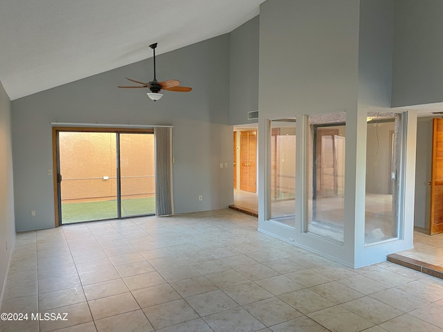 tiled spare room featuring high vaulted ceiling and ceiling fan