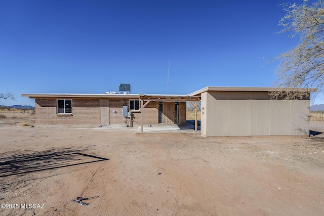 back of property featuring central AC