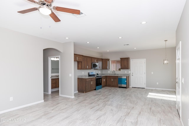 kitchen featuring pendant lighting, sink, stainless steel appliances, and ceiling fan