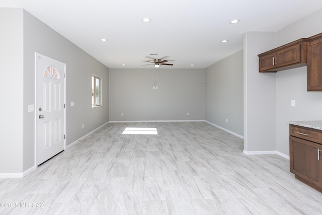 unfurnished living room featuring ceiling fan