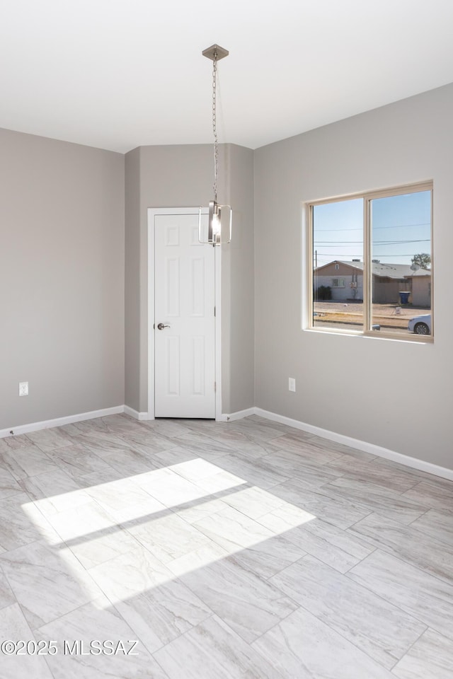 empty room featuring an inviting chandelier