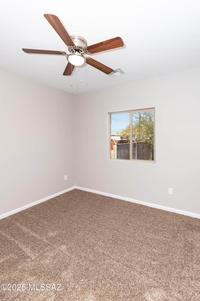 unfurnished room featuring ceiling fan and carpet