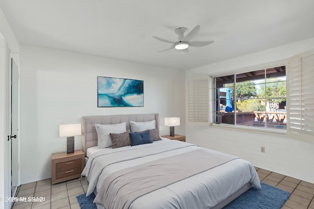 bedroom with ceiling fan and light tile patterned flooring