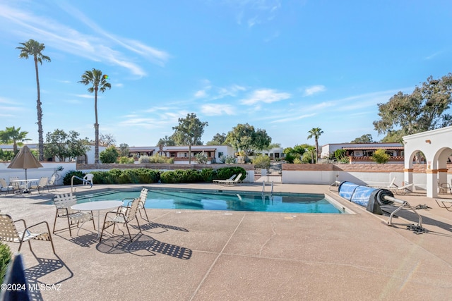 view of swimming pool with a patio area