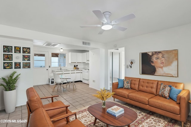 living room with sink, ceiling fan, and light tile patterned flooring