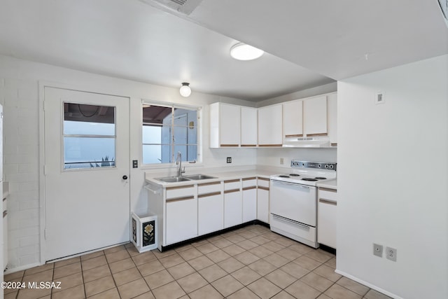 kitchen with white cabinets, light tile patterned floors, sink, and electric stove