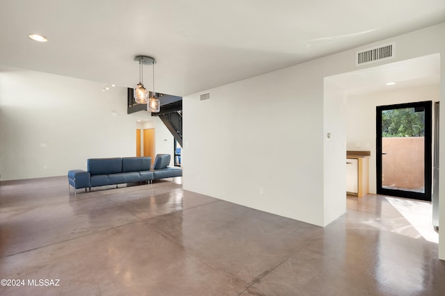 unfurnished living room featuring concrete floors