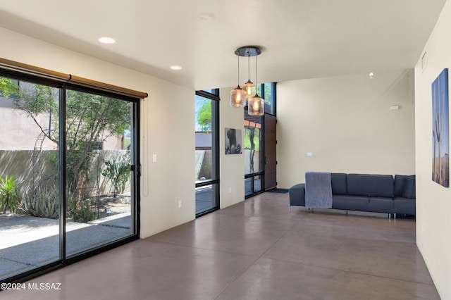 unfurnished dining area with finished concrete floors and recessed lighting