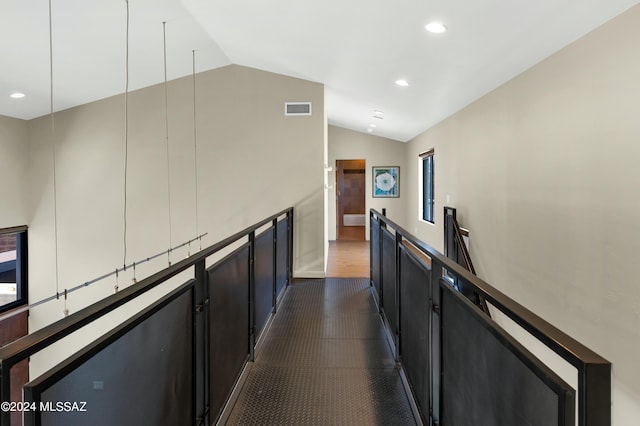 hallway featuring lofted ceiling, an upstairs landing, visible vents, and recessed lighting