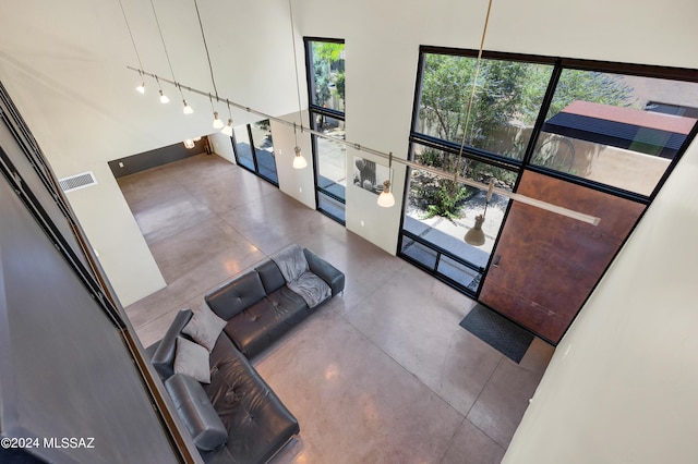 unfurnished living room featuring visible vents