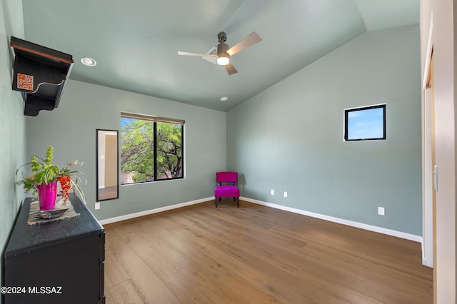 unfurnished room featuring hardwood / wood-style flooring, vaulted ceiling, and ceiling fan