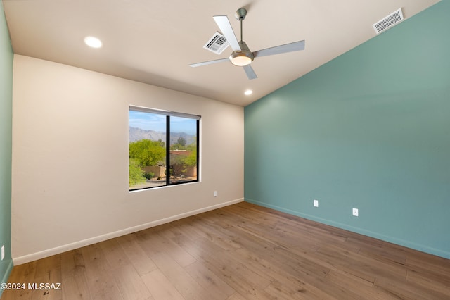 spare room featuring hardwood / wood-style flooring and ceiling fan