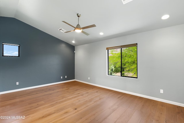 spare room featuring light hardwood / wood-style flooring, ceiling fan, and lofted ceiling