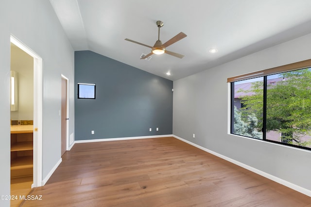 spare room with ceiling fan, wood-type flooring, and lofted ceiling