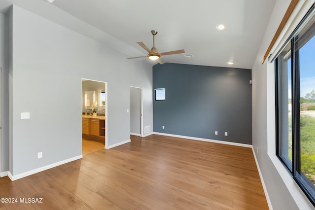 spare room featuring ceiling fan, light hardwood / wood-style flooring, and vaulted ceiling