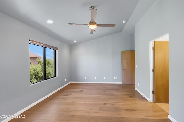 unfurnished room featuring ceiling fan, light hardwood / wood-style flooring, and vaulted ceiling