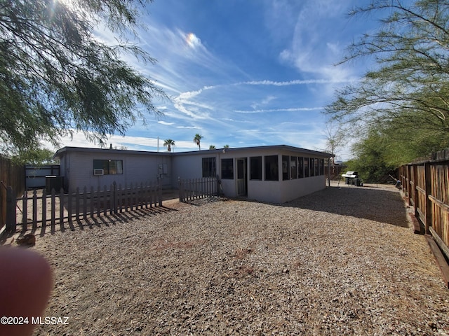 back of house featuring a sunroom