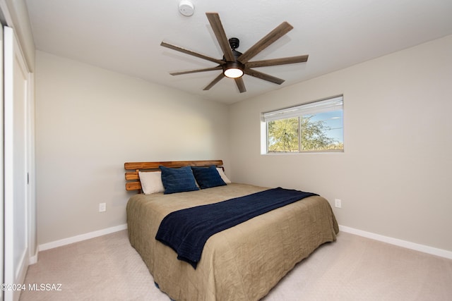 bedroom featuring ceiling fan and light carpet