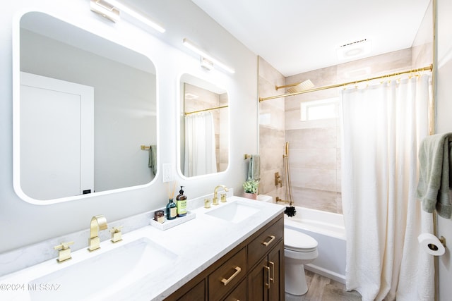 full bathroom featuring hardwood / wood-style flooring, vanity, toilet, and shower / tub combo with curtain